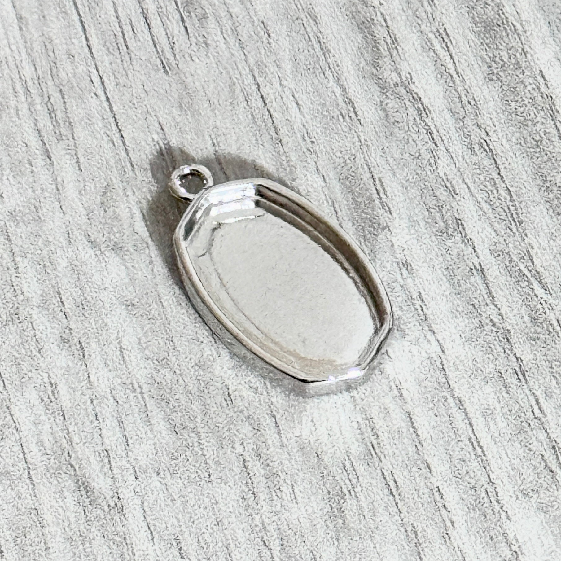 small oval shaped bezel top loop silver