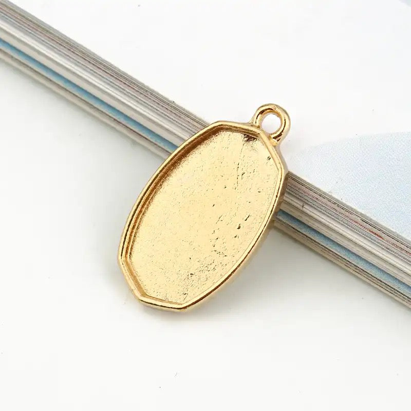 small oval shaped bezel top loop gold