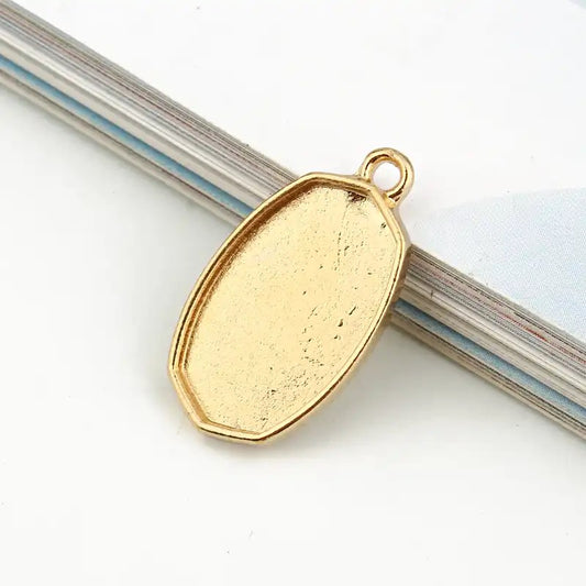 small oval shaped bezel top loop gold